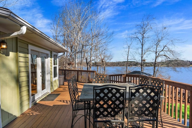 wooden deck featuring outdoor dining area and a water view