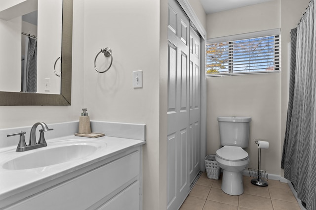 full bath featuring baseboards, toilet, tile patterned flooring, vanity, and a closet