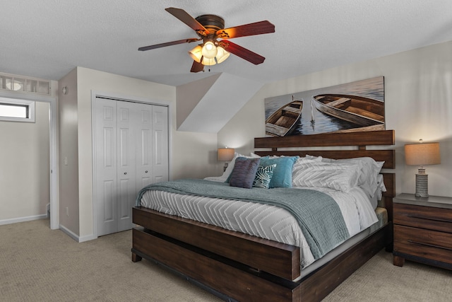 bedroom featuring light carpet, a closet, a textured ceiling, and visible vents