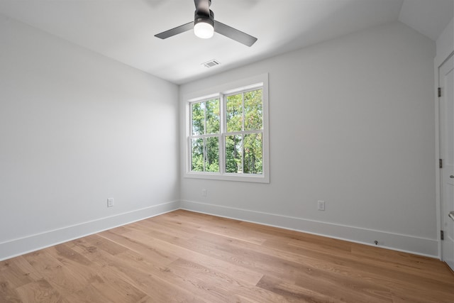 empty room with baseboards, ceiling fan, visible vents, and light wood-style floors