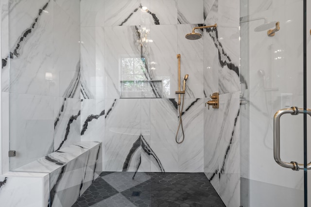 full bath with an inviting chandelier and a marble finish shower