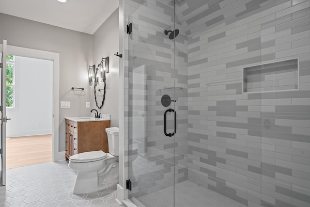 bathroom featuring tile patterned flooring, vanity, and a shower stall