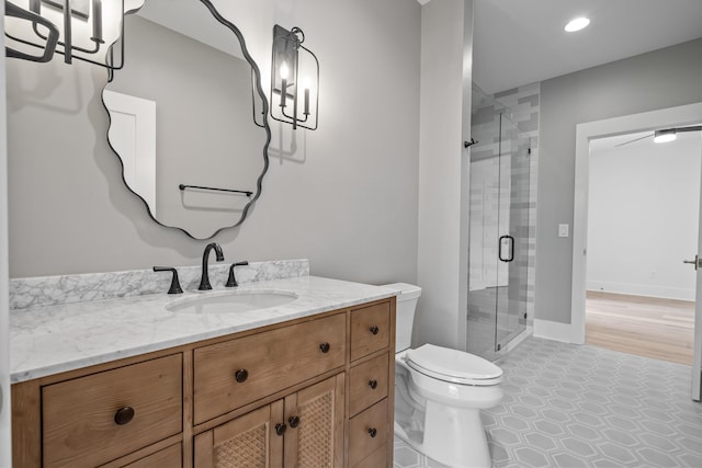 full bathroom with toilet, a stall shower, tile patterned flooring, and vanity