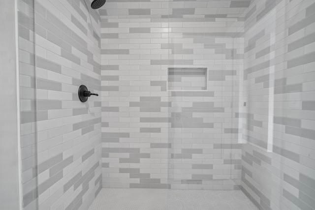 full bath with a tile shower