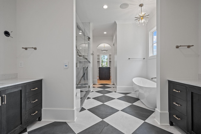 bathroom with a stall shower, tile patterned floors, a soaking tub, and vanity