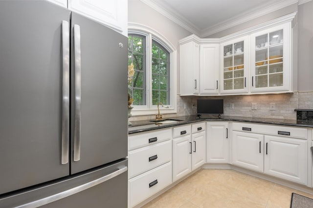 1320 Dejarnet Pl, Greensboro, GA 30642 - kitchen featuring freestanding refrigerator, backsplash, glass insert cabinets, dark stone counters, and white cabinets