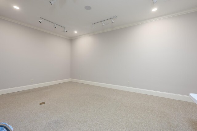 1320 Dejarnet Pl, Greensboro, GA 30642 - empty room featuring rail lighting, ornamental molding, light colored carpet, and recessed lighting