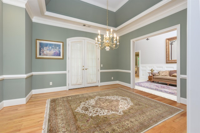 1320 Dejarnet Pl, Greensboro, GA 30642 - spare room featuring french doors, wood finished floors, a chandelier, and crown molding