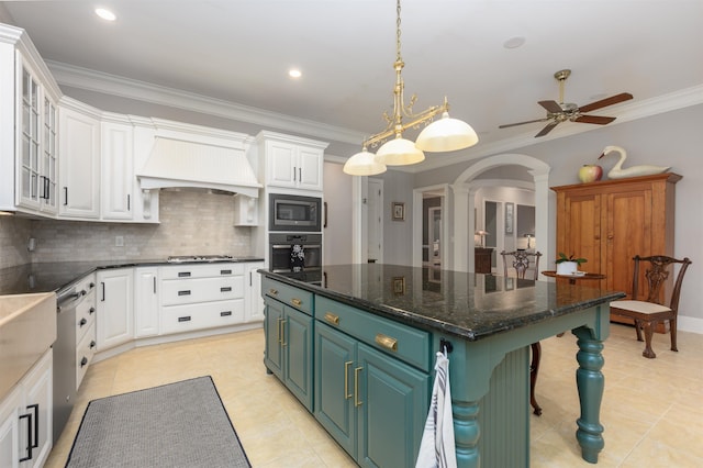 1320 Dejarnet Pl, Greensboro, GA 30642 - kitchen with stainless steel appliances, white cabinets, custom range hood, ornamental molding, and recessed lighting