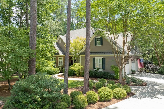 1320 Dejarnet Pl, Greensboro, GA 30642 - view of front of property featuring a standing seam roof, driveway, a metal roof, and a garage