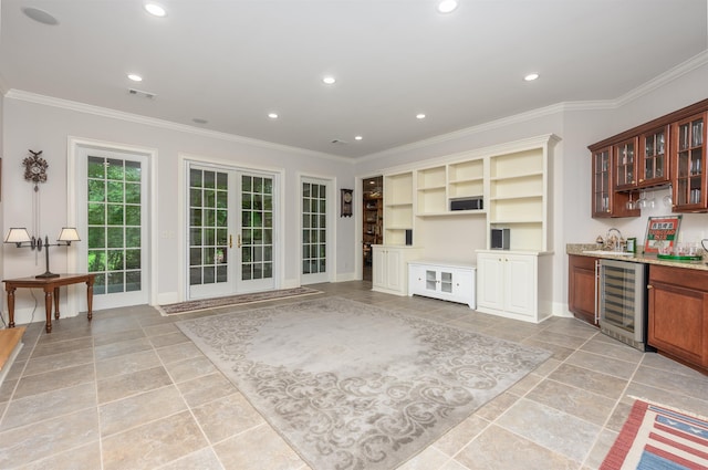 1320 Dejarnet Pl, Greensboro, GA 30642 - kitchen featuring beverage cooler, crown molding, glass insert cabinets, recessed lighting, and french doors
