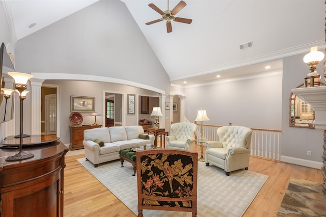 1320 Dejarnet Pl, Greensboro, GA 30642 - living area featuring a ceiling fan, high vaulted ceiling, light wood-style floors, arched walkways, and ornate columns