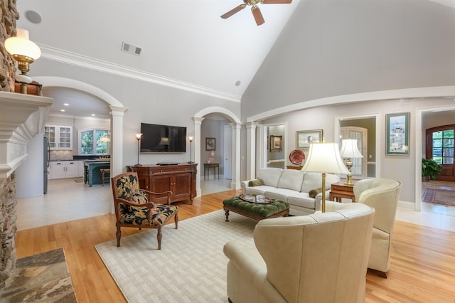 1320 Dejarnet Pl, Greensboro, GA 30642 - living area with decorative columns, ceiling fan, arched walkways, high vaulted ceiling, and light wood-type flooring