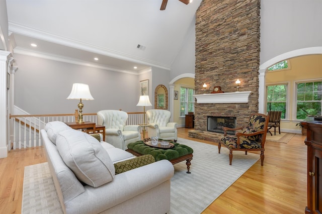 1320 Dejarnet Pl, Greensboro, GA 30642 - living area featuring arched walkways, a stone fireplace, plenty of natural light, high vaulted ceiling, and ornate columns