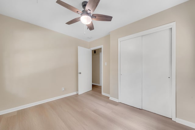 unfurnished bedroom featuring a closet, ceiling fan, and light wood-type flooring