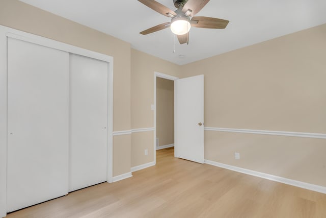 unfurnished bedroom with ceiling fan, a closet, and light hardwood / wood-style flooring