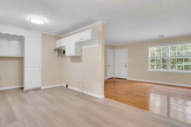 interior space featuring white cabinetry, crown molding, and light hardwood / wood-style flooring