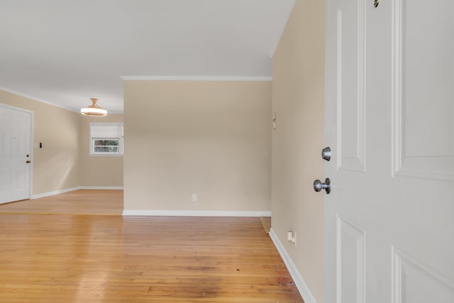 interior space with ornamental molding and light hardwood / wood-style flooring