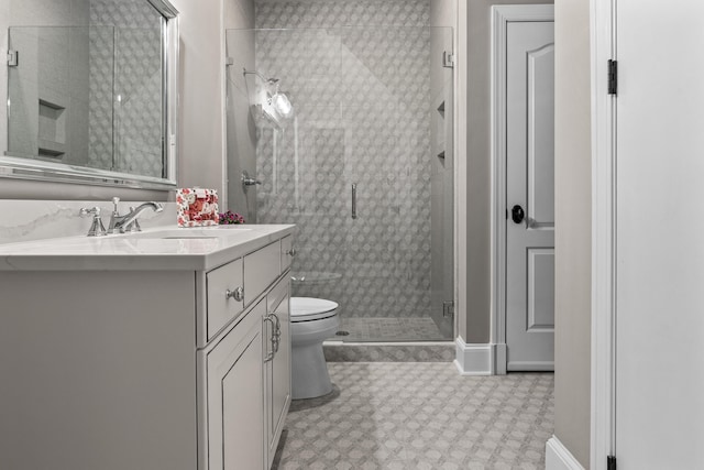 bathroom with vanity, toilet, and an enclosed shower