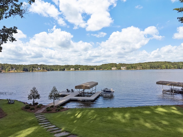 view of dock featuring a lawn and a water view