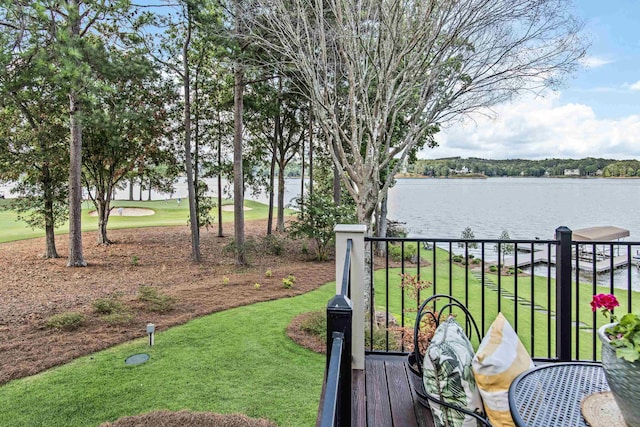 wooden deck featuring a water view and a yard