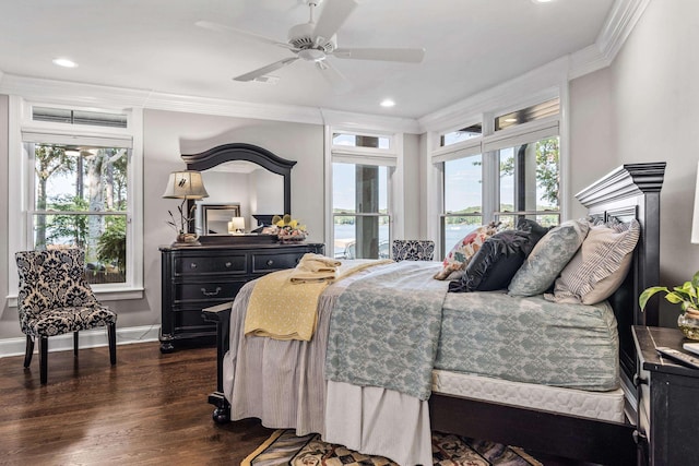 bedroom with multiple windows, crown molding, and dark hardwood / wood-style flooring