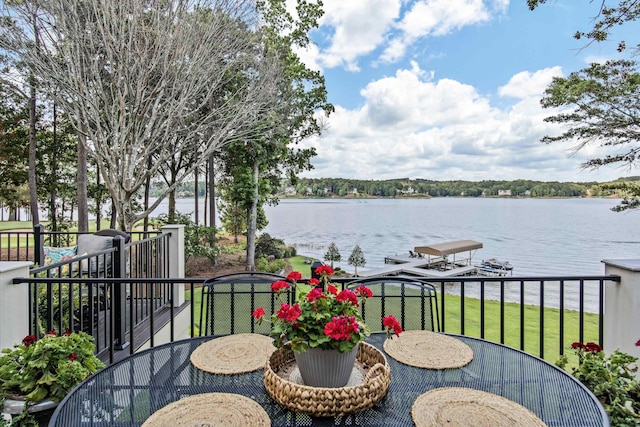 balcony featuring a water view and a boat dock