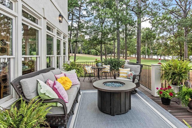 view of patio / terrace featuring a deck and an outdoor fire pit