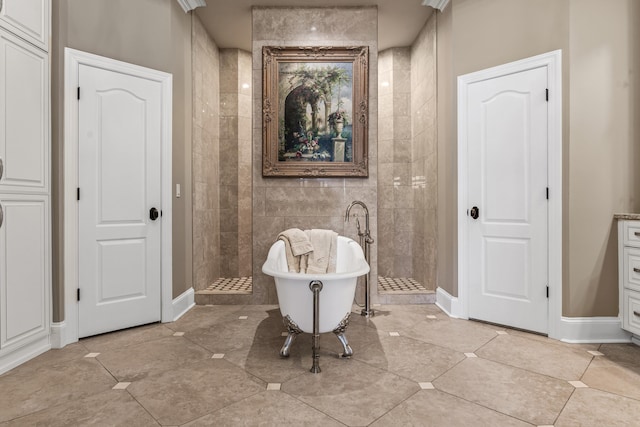 bathroom with vanity, tile patterned floors, and a tub to relax in