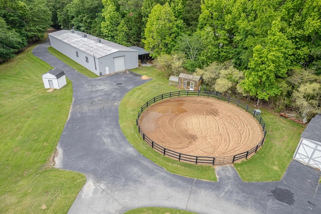 birds eye view of property featuring a view of trees