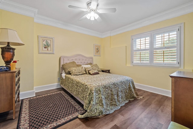 bedroom featuring ornamental molding, ceiling fan, baseboards, and dark wood finished floors