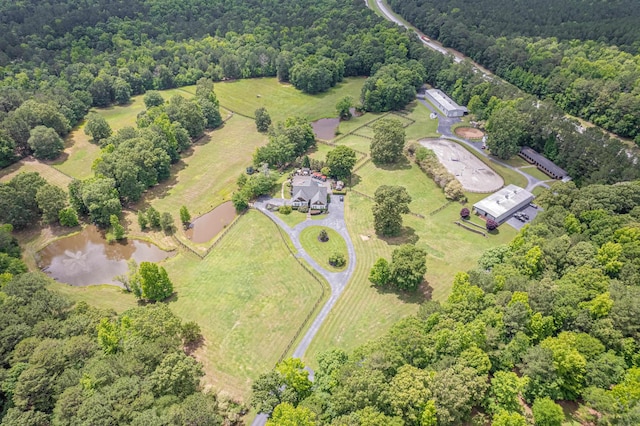 bird's eye view with a water view and a forest view