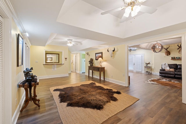 interior space featuring dark wood-style floors, baseboards, and ceiling fan