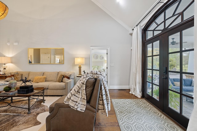living area featuring ornamental molding, high vaulted ceiling, french doors, and dark wood finished floors