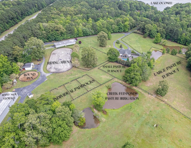 drone / aerial view featuring a forest view