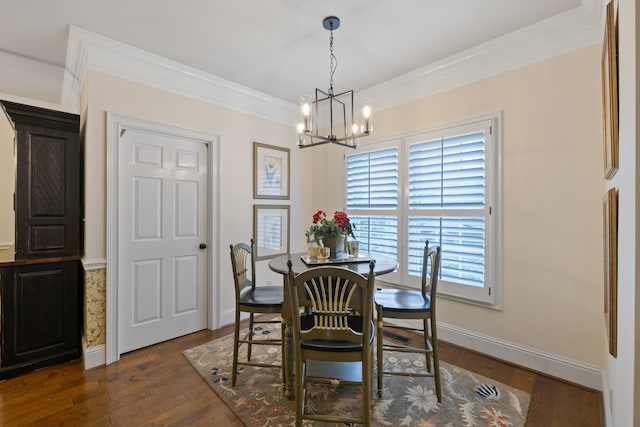 dining space with ornamental molding, dark wood-style flooring, a chandelier, and baseboards
