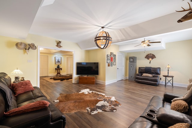 living area with baseboards, wood finished floors, and ceiling fan