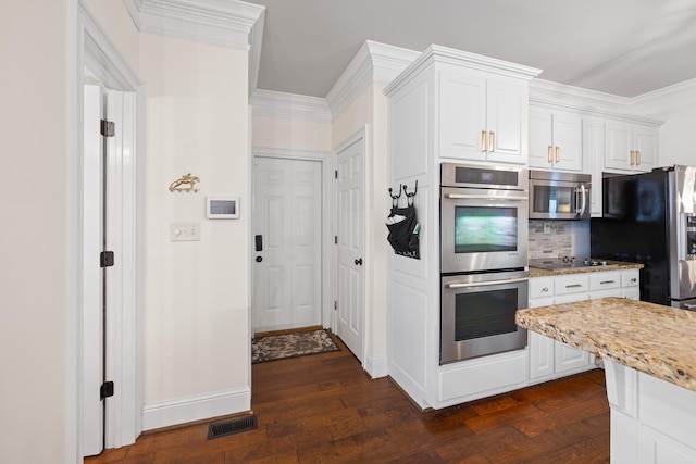 kitchen with white cabinetry, visible vents, appliances with stainless steel finishes, and dark wood-type flooring