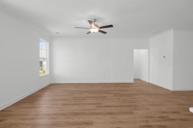 unfurnished room with crown molding, light wood-style flooring, baseboards, and ceiling fan