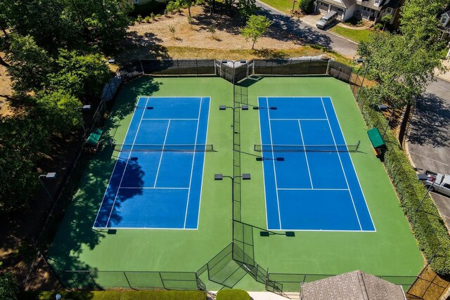 view of tennis court featuring fence