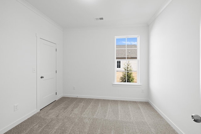 carpeted empty room with ornamental molding, plenty of natural light, and visible vents