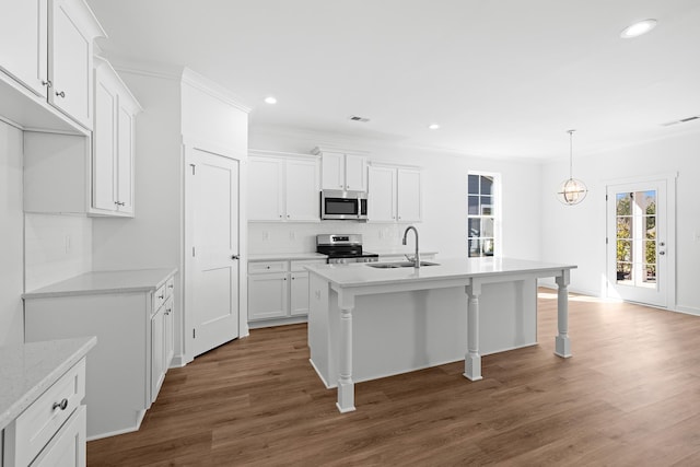 kitchen featuring visible vents, dark wood-style flooring, a sink, stainless steel appliances, and backsplash