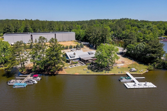 bird's eye view with a water view and a wooded view