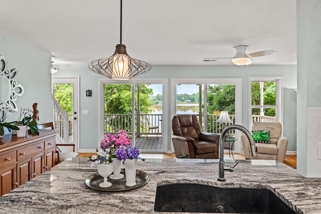 1601 Heidi Trl, Buckhead, GA 30625 - dining area with a water view, wood finished floors, baseboards, and a ceiling fan