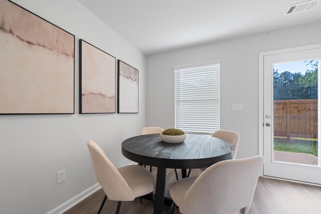 100 Lena Ln, Eatonton, GA 31024 - dining space featuring visible vents, wood finished floors, and baseboards