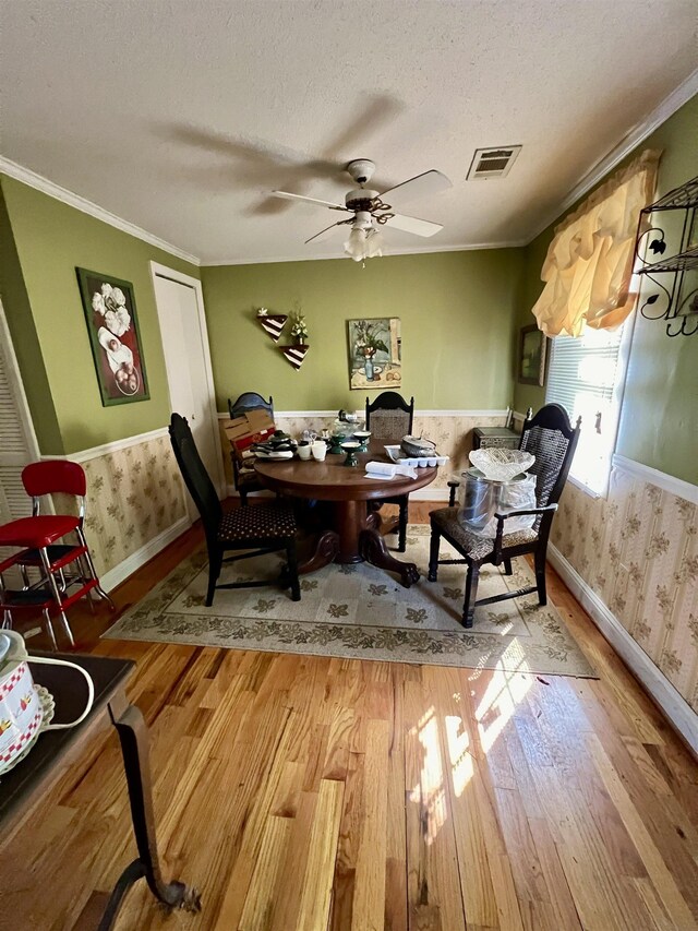 office featuring crown molding, ceiling fan, wood-type flooring, and a textured ceiling