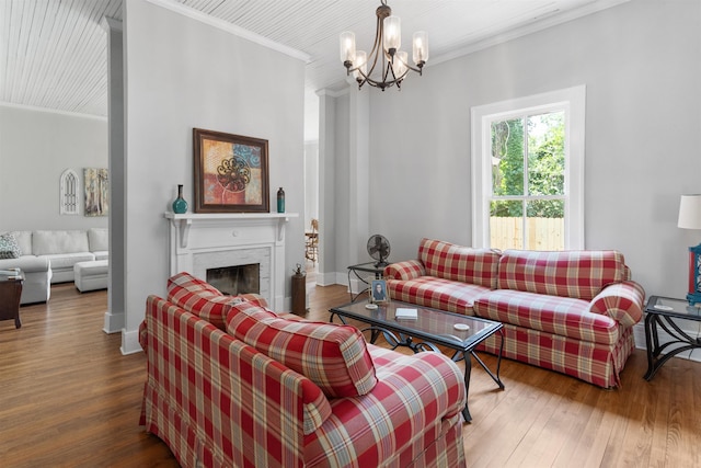 living room featuring crown molding, dark wood-type flooring, and a chandelier