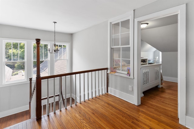 hall with a chandelier and hardwood / wood-style floors