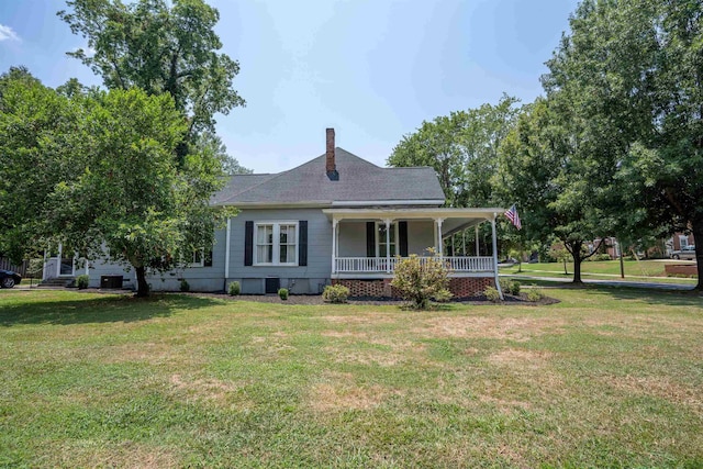 rear view of property with a lawn and a porch