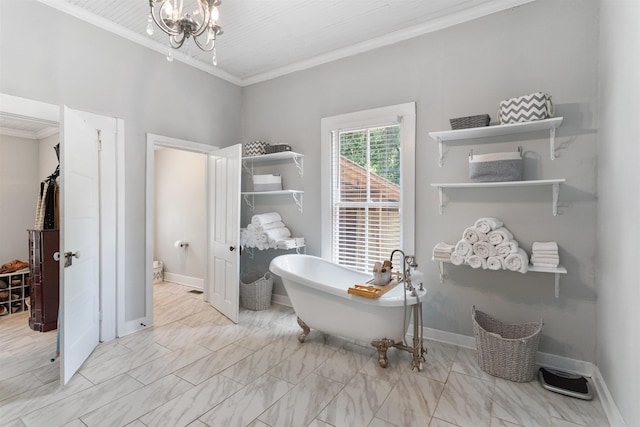 bathroom with a washtub, crown molding, toilet, and a chandelier